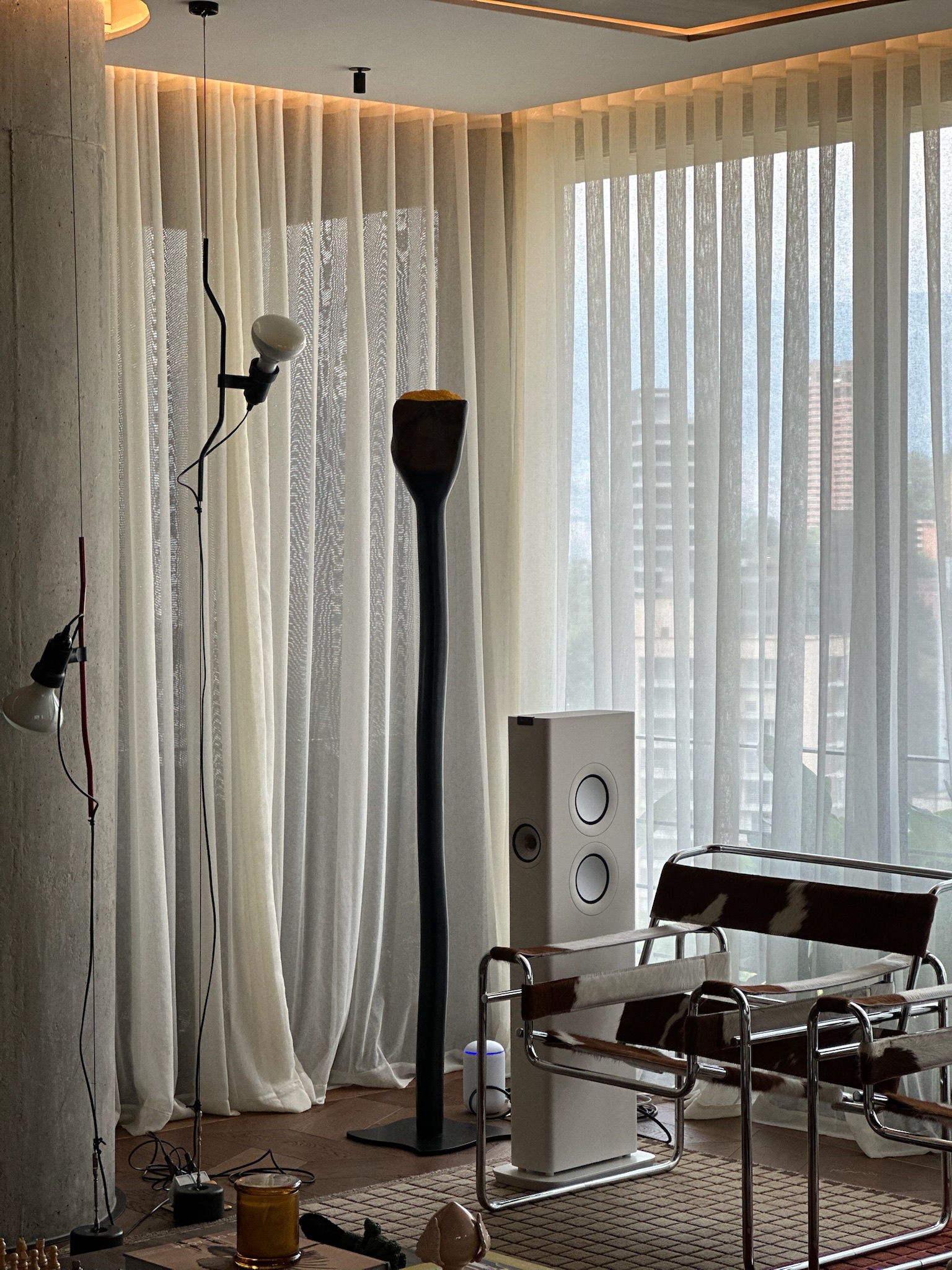 Custom sheer drapery wrapping a floor-to-ceiling corner window