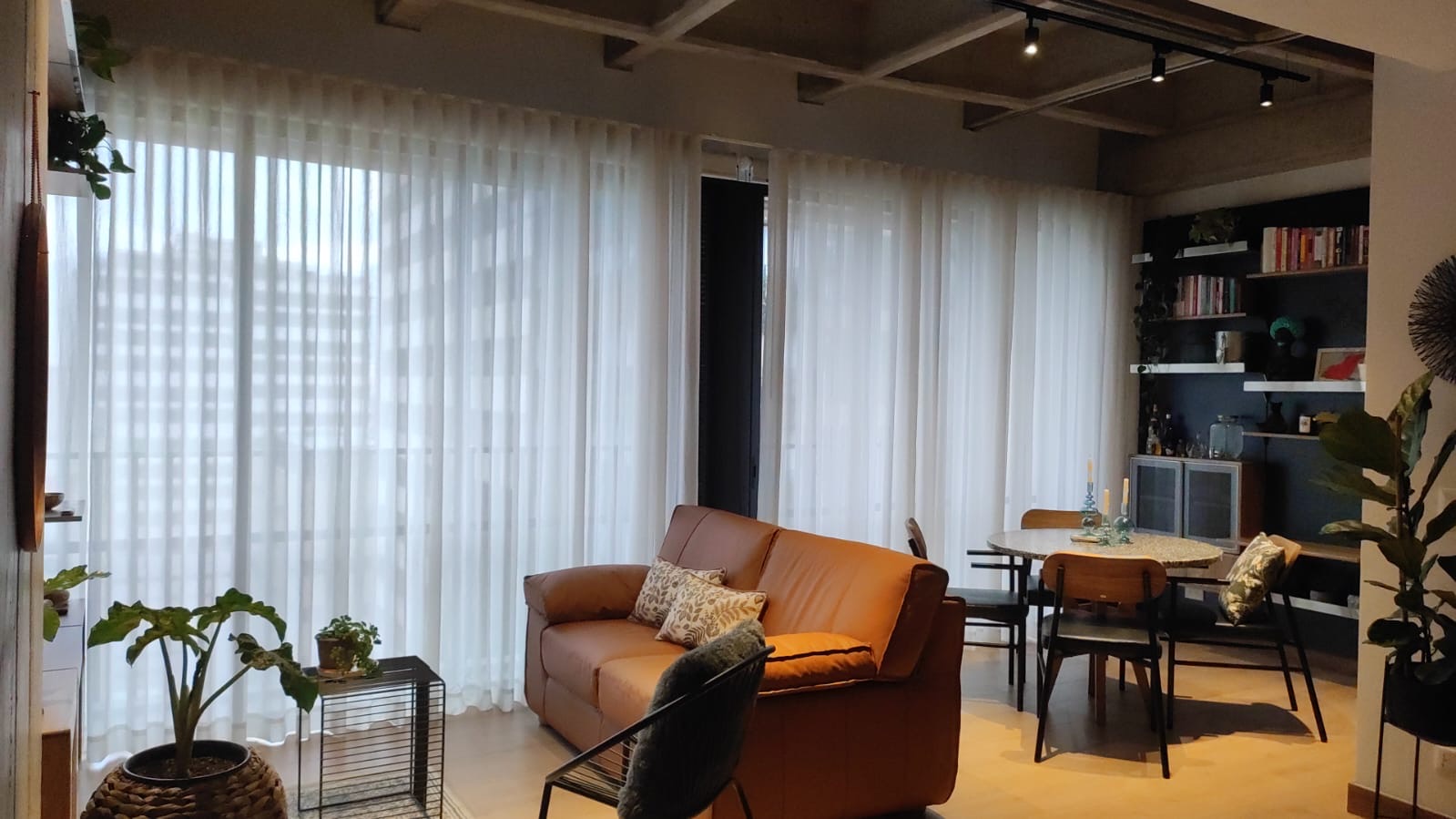 Custom sheer drapery across a living room wall