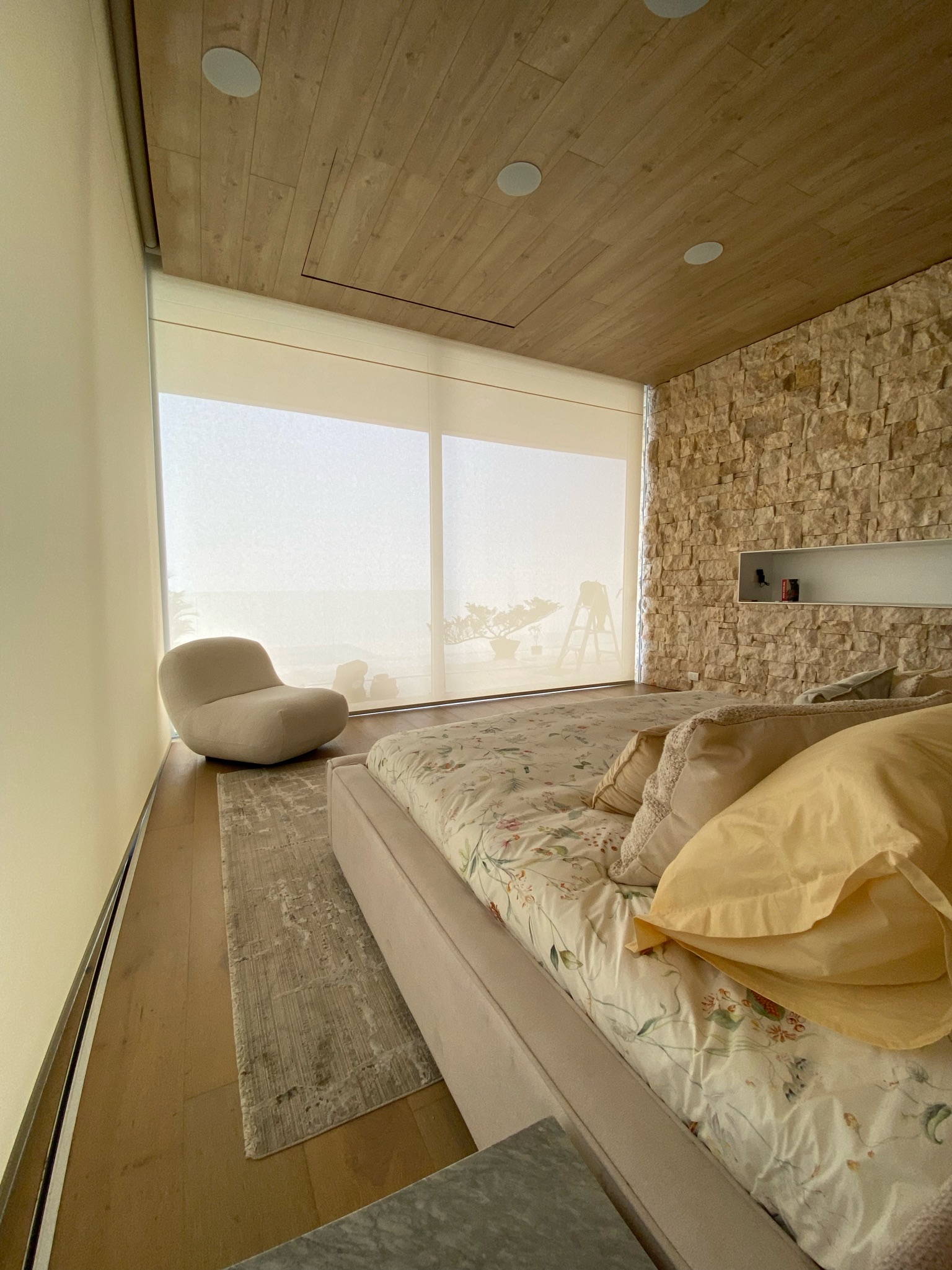 Motorized solar roller shades in a Miami bedroom